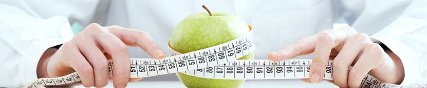 Girl measures an apple with inch tape